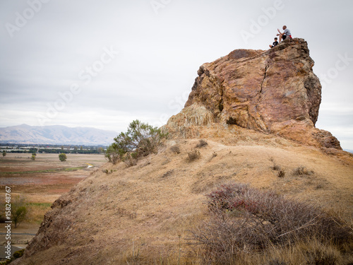 Father and son climbing peak in Coyote Hills Regional Park, Newark, California, USA by San Francisco Bay