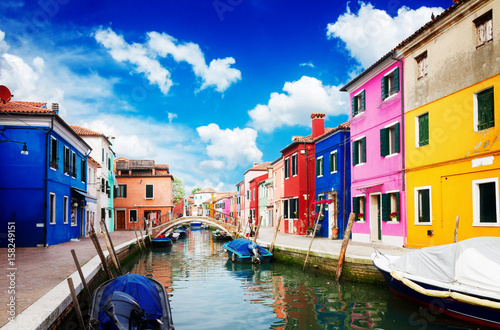 multicolored houses over canal with boats, street of Burano island, Venice, Italy, retro toned