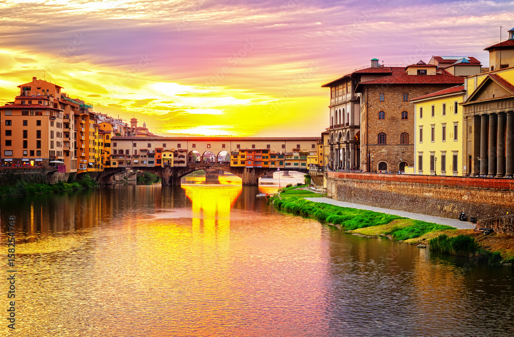famous bridge Ponte Vecchio over Arno river at sunset, Florence, Italy, retro toned
