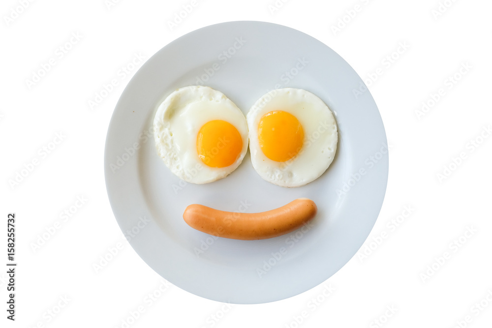 Smiling face frying eggs breakfast on a plate isolated white background. Smiling face frying eggs breakfast on a plate isolated white background.