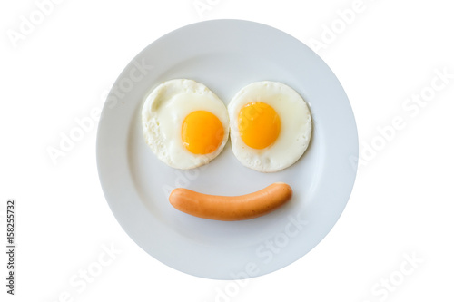 Smiling face frying eggs breakfast on a plate isolated white background.