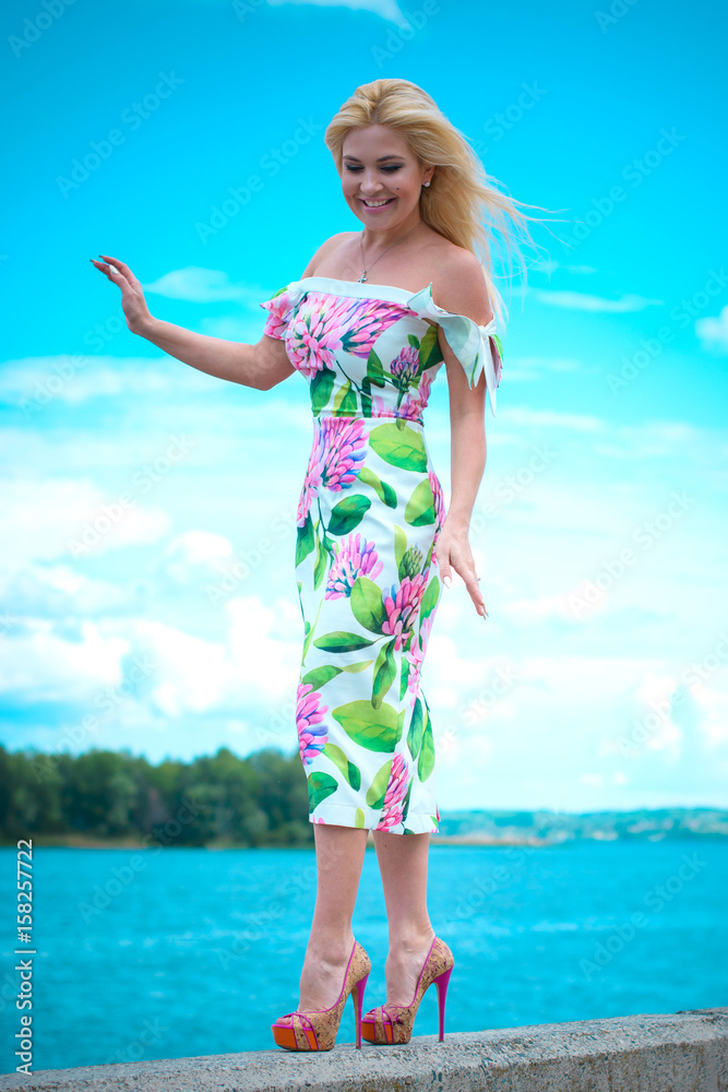 Beautiful woman at the resort resting on the waterfront. Romantic style in clothes and image