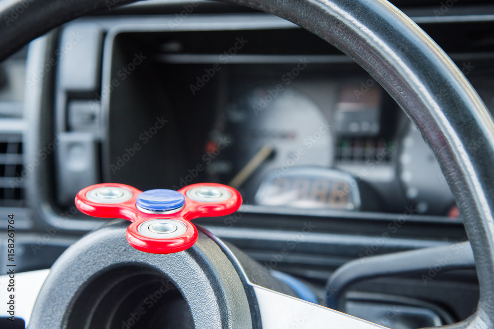 Close-up Spinner-Fidget is a toy for shunting time being in the car in standing in an automotive traffic jam