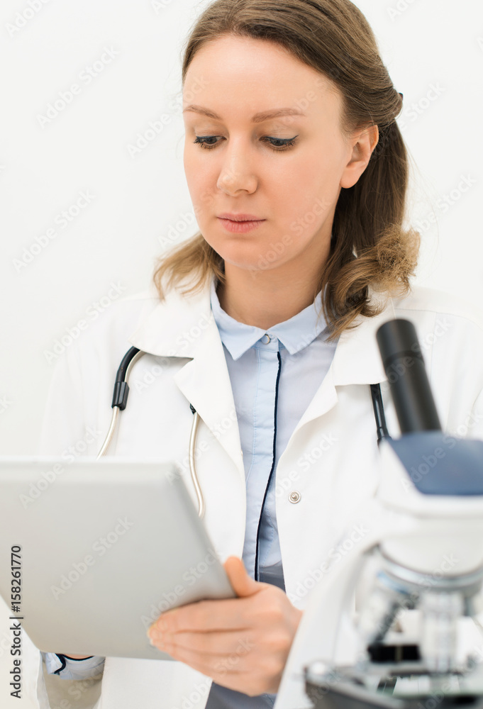 Doctor writing results of the test in laboratory. Doctor writing results of the test in laboratory.