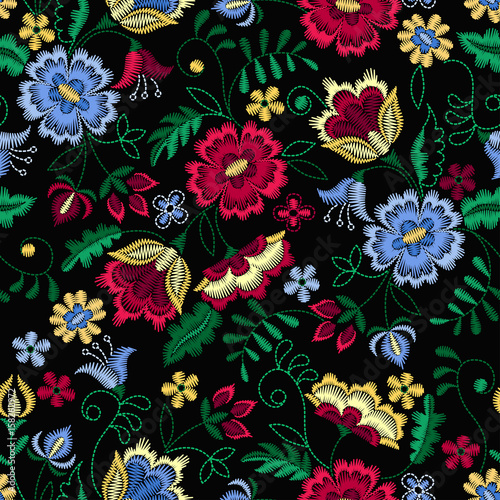 Embroidery seamless pattern with beautiful flowers. Vector floral ornament on black background. Embroidery for fashion textile and fabric.