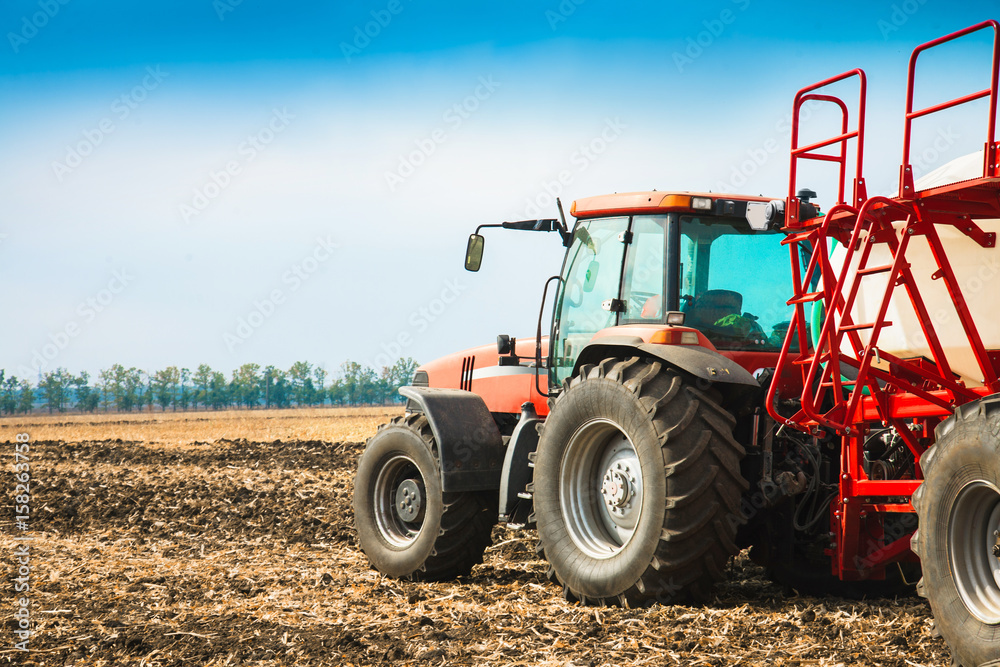 Tractor with tanks in the field. Agricultural machinery and farming. Tractor with tanks in the field. Agricultural machinery and farming.