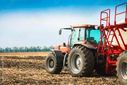 Tractor with tanks in the field. Agricultural machinery and farming.