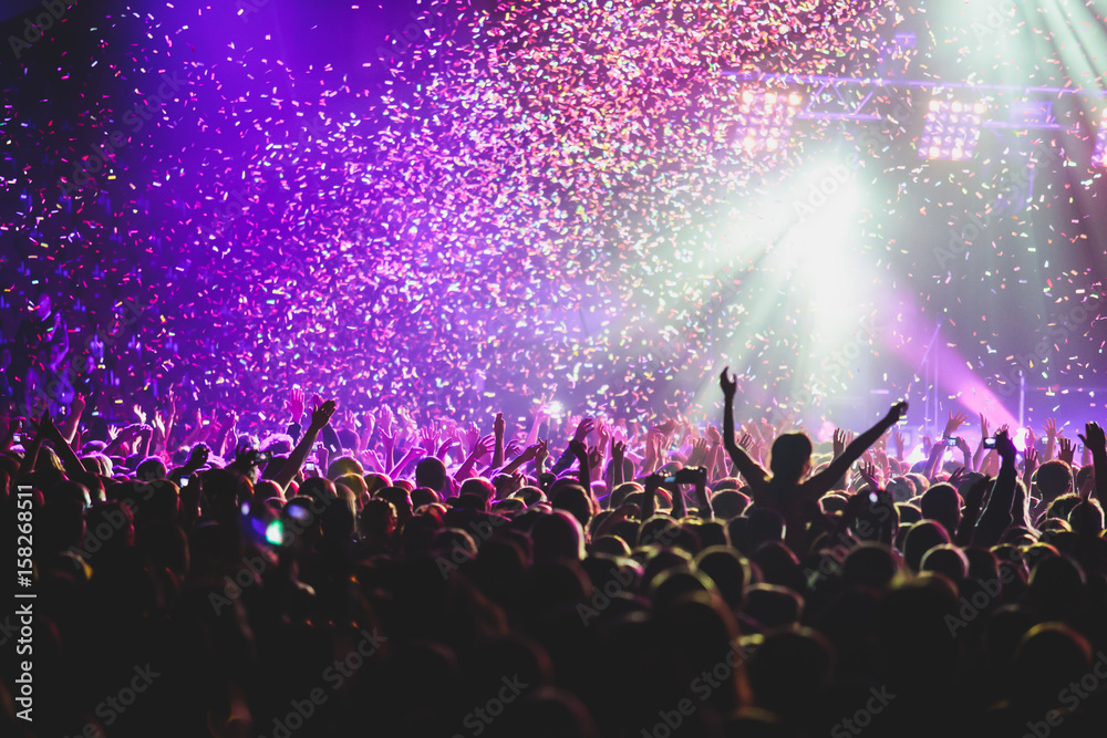 View of rock concert show in big concert hall, with crowd and stage lights, a crowded concert hall with scene lights, rock show performance, with people silhouette