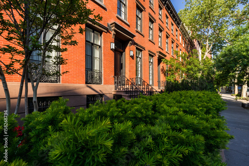 Photography Nineteenth century townhouses with brick facades and wrought iron railings
