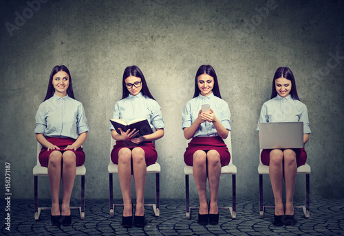 Modern technology vs traditional sources of information. Women with book, laptop and mobile phone photo