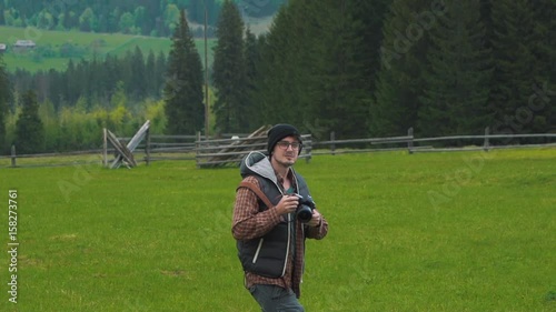 Photographer takes pictures on the go in nature. photo