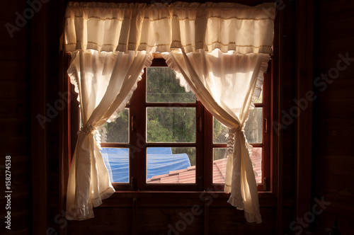 White curtainson wood window frame