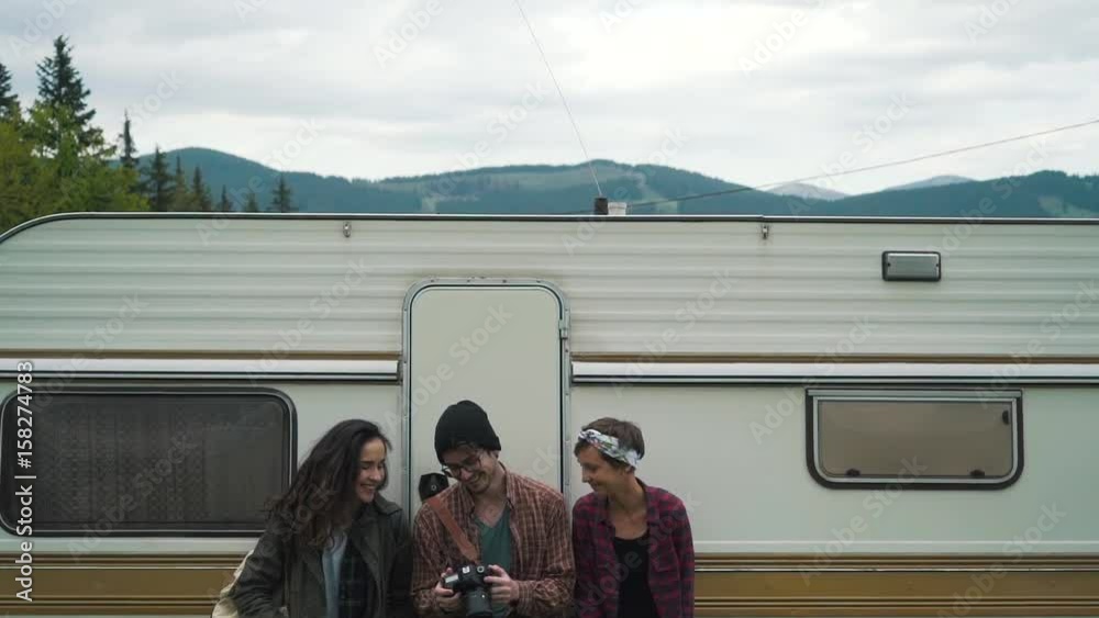 Happy toutists smiling near mobile home. Happy toutists smiling near mobile home.