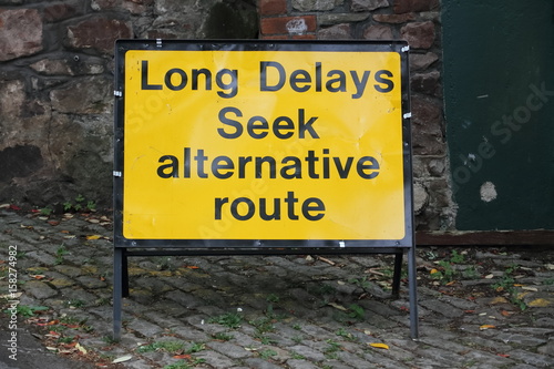 Sign: Long Delays Seek alternative route