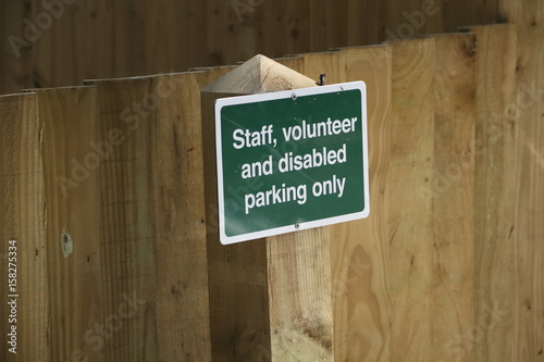 Sign: "Staff, Volunteer, and Disabled Parking Only"