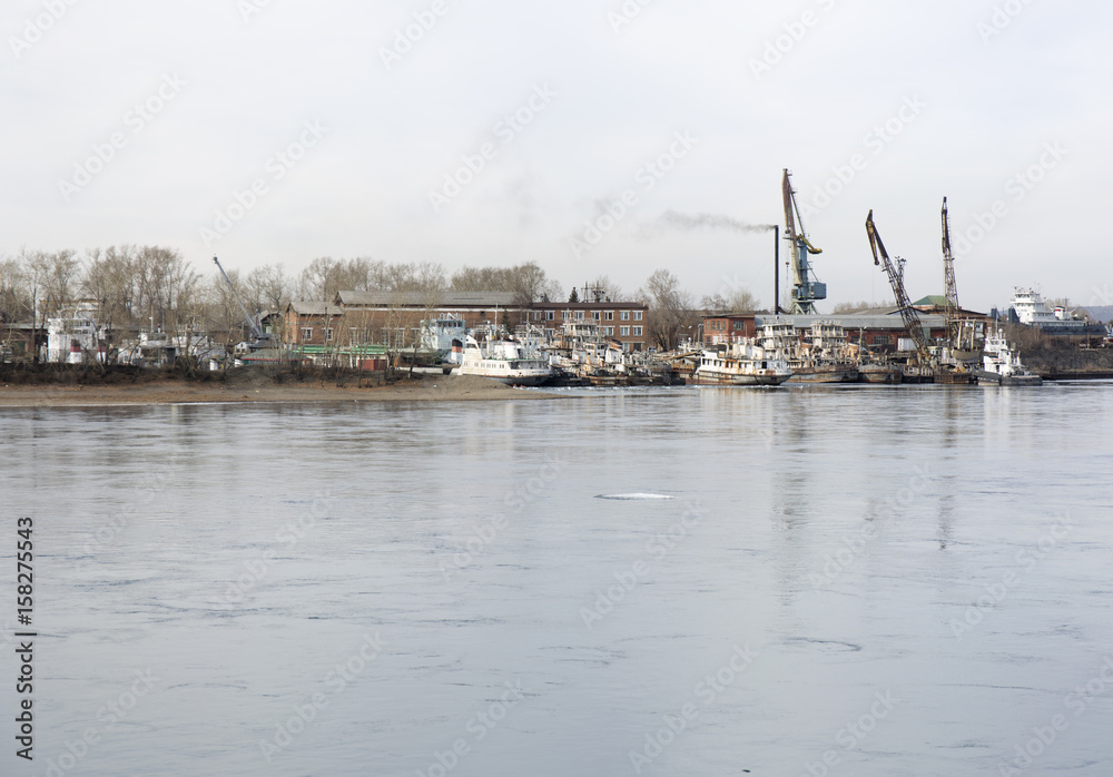 Harbor cranes at cargo port on the Siberia river.