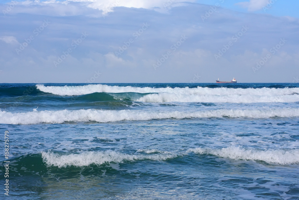 Fototapeta premium A ship in the sea is a view from the shore.