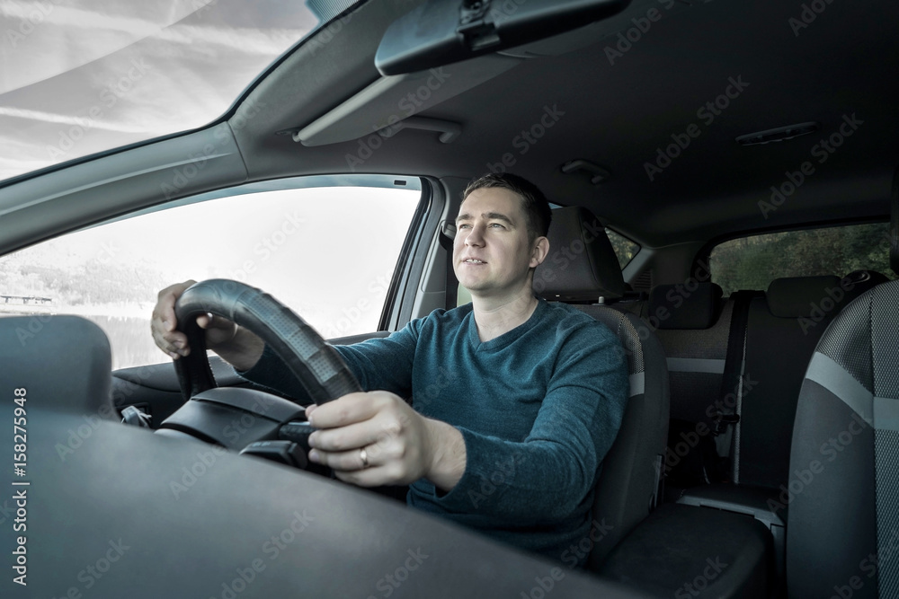 Man is driving a car Man is driving a car