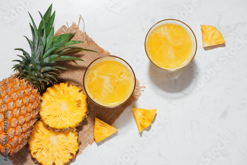 Top view of fresh pineapple juice in the glass with pineapple fruit