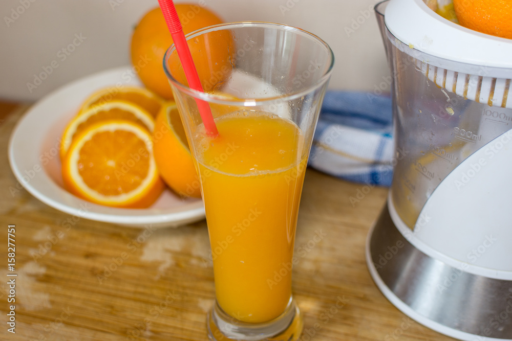 Orange juice. fruits and Electric Juice Machine on wooden desk Orange juice. fruits and Electric Juice Machine on wooden desk