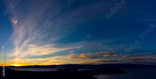 Panorama of the cape and the island of Kharantsi on the alkhon at sunset © Baikal360