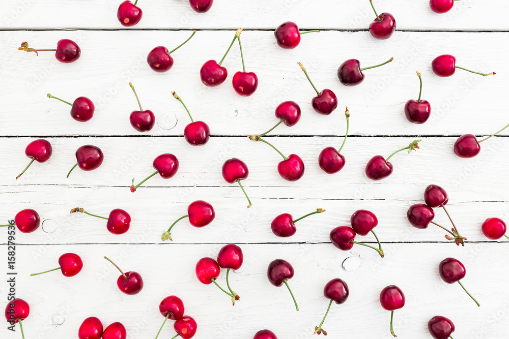 Pattern made of red cherry on white rustic table. Flat lay. Top view. Summer berries Pattern made of red cherry on white rustic table. Flat lay. Top view. Summer berries