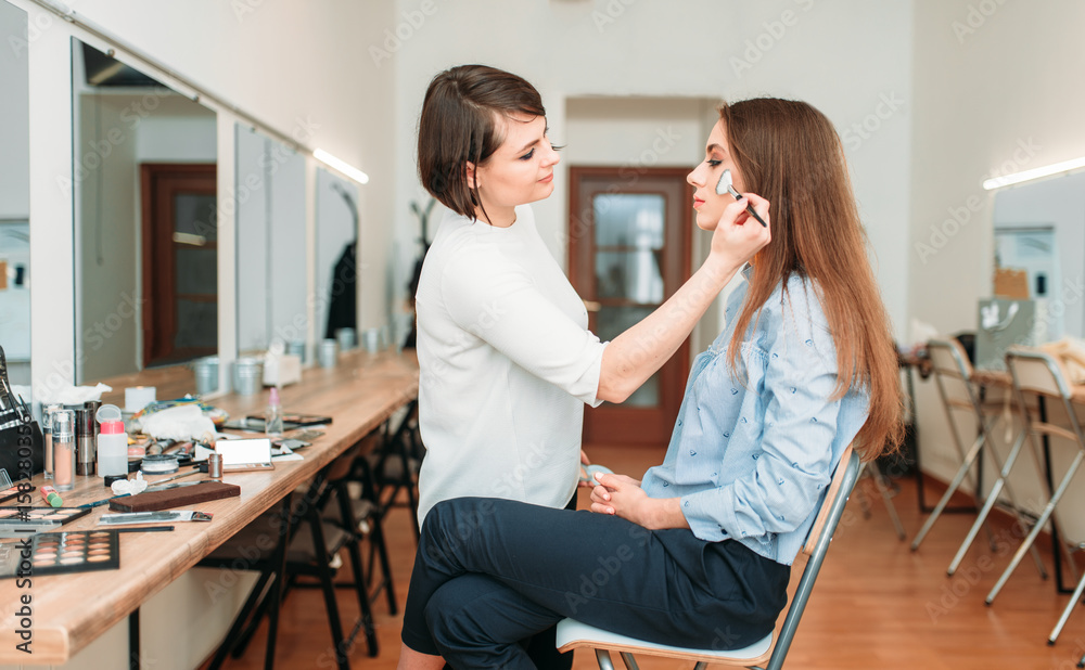 Female make up artist work with woman face Female make up artist work with woman face