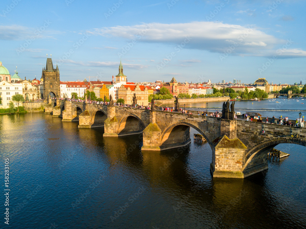 Fototapeta Scenic summer sunset aerial view of the Old Town pier architecture and Charles Bridge over Vltava river in Prague, Czech Republic
