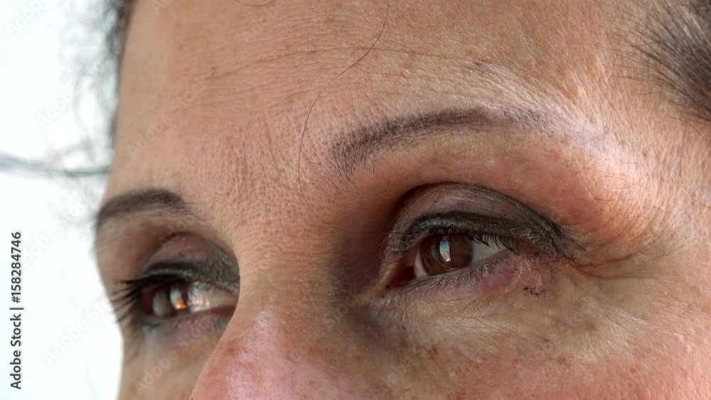 bags of blinking eyes with one hair on wrinkled forehead of mature Caucasian woman with Arabic and Middle Eastern somatic traits bags of blinking eyes with one hair on wrinkled forehead of mature Caucasian woman with Arabic and Middle Eastern somatic traits