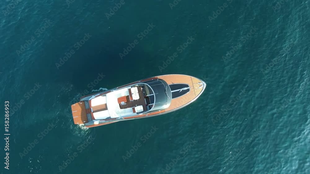 Perpendicular aerial view of luxury boat anchored in a small bay. Perpendicular aerial view of luxury boat anchored in a small bay.