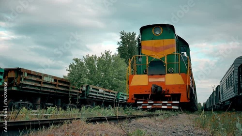 Close-up of diesel train locomotive slowly moving along tracks