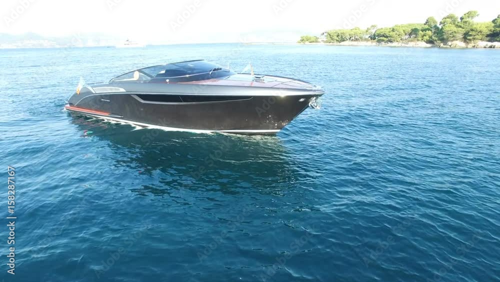 Aerial view of luxury boat anchored in a small bay.