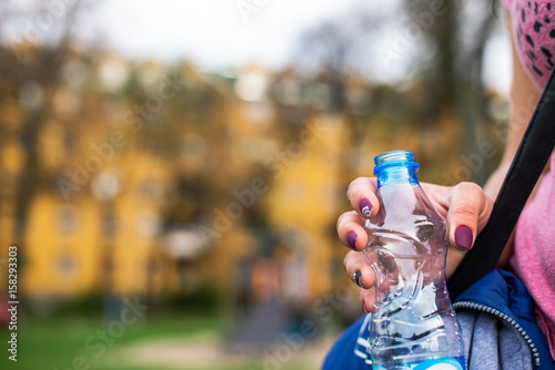 Woman holding bottle of water