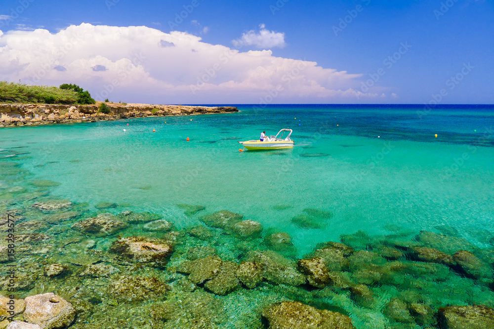 Boat in sea bay with turquoise water near Protaras, Cyprus island