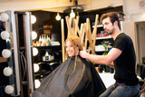 Young blonde is happy at hair saloon