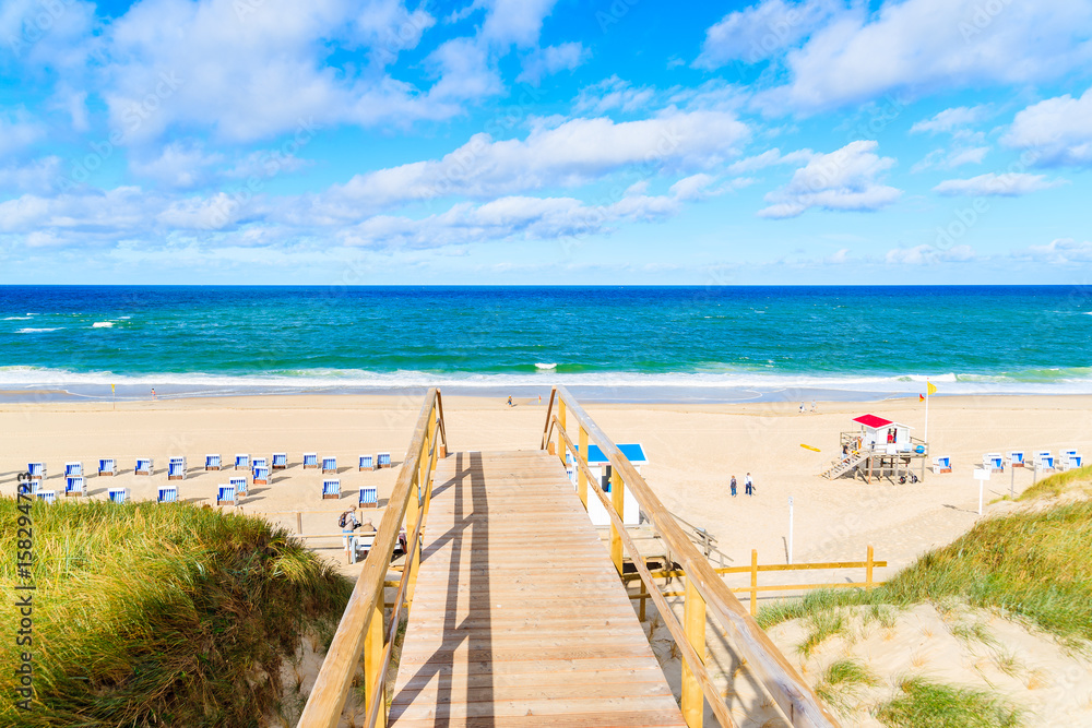 Walkway to beautiful beach in Westerland village on Sylt island, North Sea, Germany Walkway to beautiful beach in Westerland village on Sylt island, North Sea, Germany