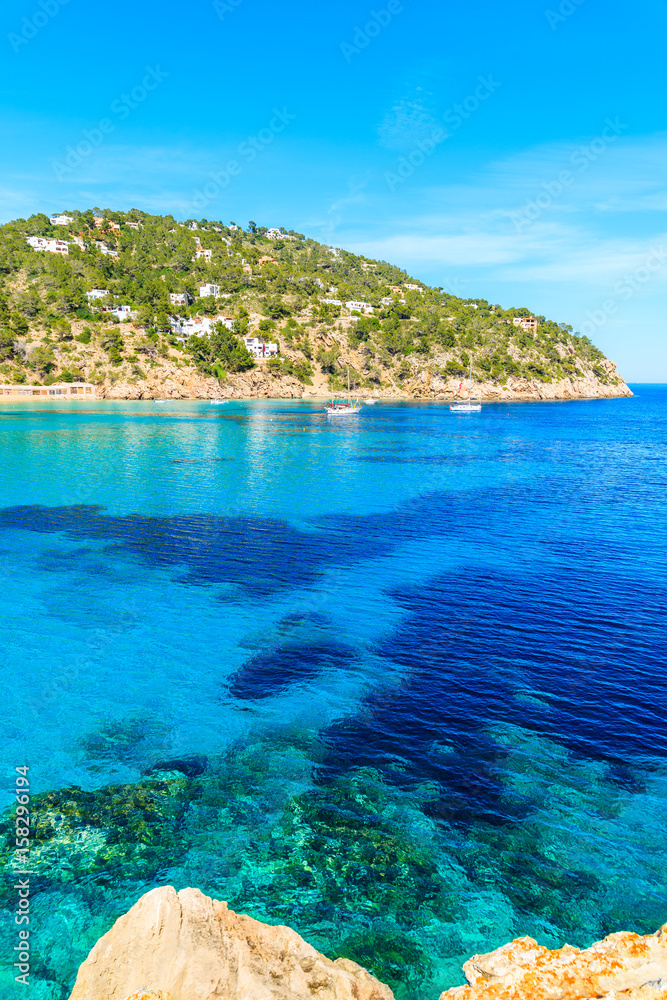 Blue azure sea water on coast of Cala San Vicente bay in northern part of Ibiza island, Spain Blue azure sea water on coast of Cala San Vicente bay in northern part of Ibiza island, Spain