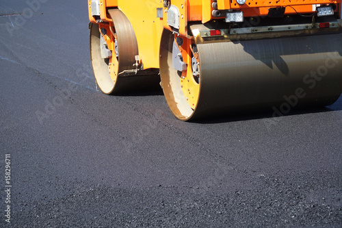 close up on compactor roller paving the asphalt road © nd700