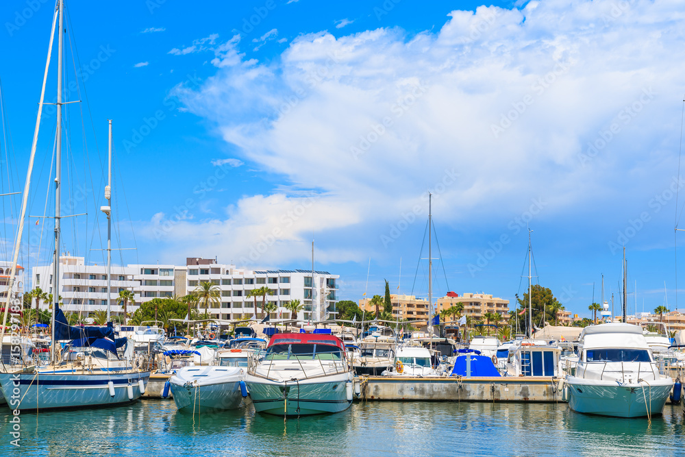 Motor and sailing boats anchoring in Santa Eularia modern marina, Ibiza island, Spain