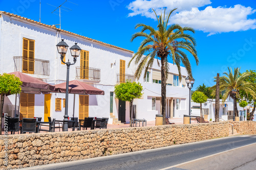 Typical Spanish style houses and palm tree on street of Sant Josep de sa Talaia town, Ibiza island, Spain photo
