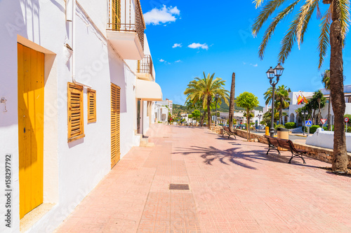 Typical Spanish style houses and palm trees on street of Sant Josep de sa Talaia town, Ibiza island, Spain photo