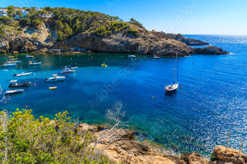 Fishing and sailing boats on blue sea water in Cala Vadella bay, Ibiza island, Spain © pkazmierczak