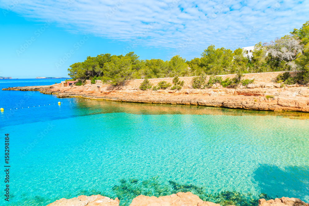View of beautiful Cala Gracioneta bay with crystal clear sea water at early morning, Ibiza island, Spain