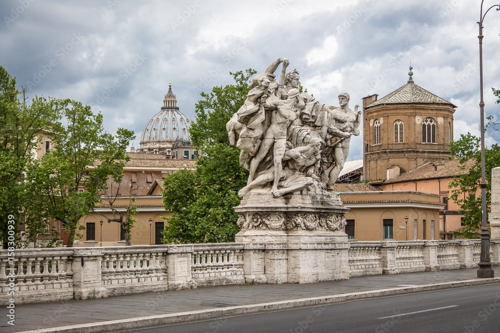 Famous Statue of the Ponte Vittorio Emanuele II and St. Peter's basilica dome  - Rome, Italy