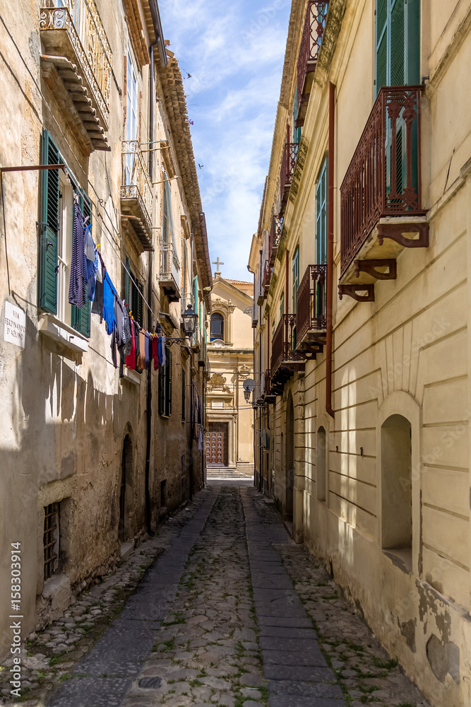 Narrow street and church in downtown Tropea - Tropea, Calabria, Italy