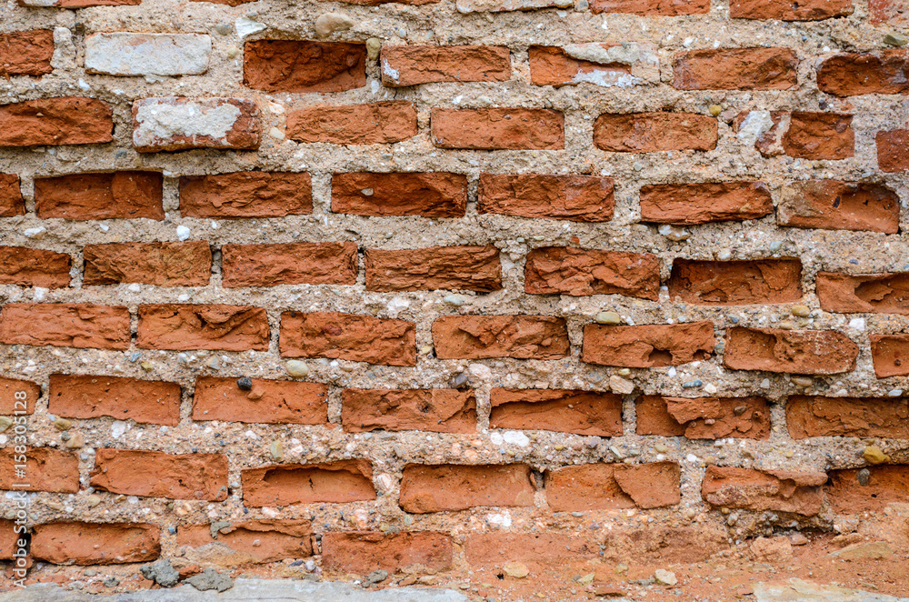 Red brick wall texture shattered by time. Grunge background Red brick wall texture shattered by time. Grunge background