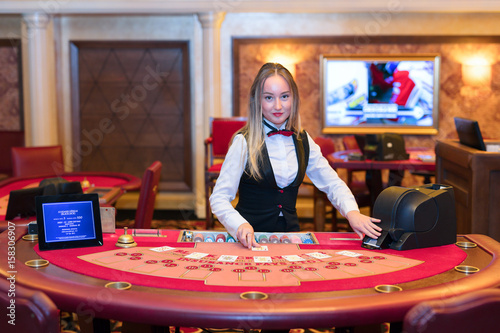 Cute lady casino dealer at Black Jack table.