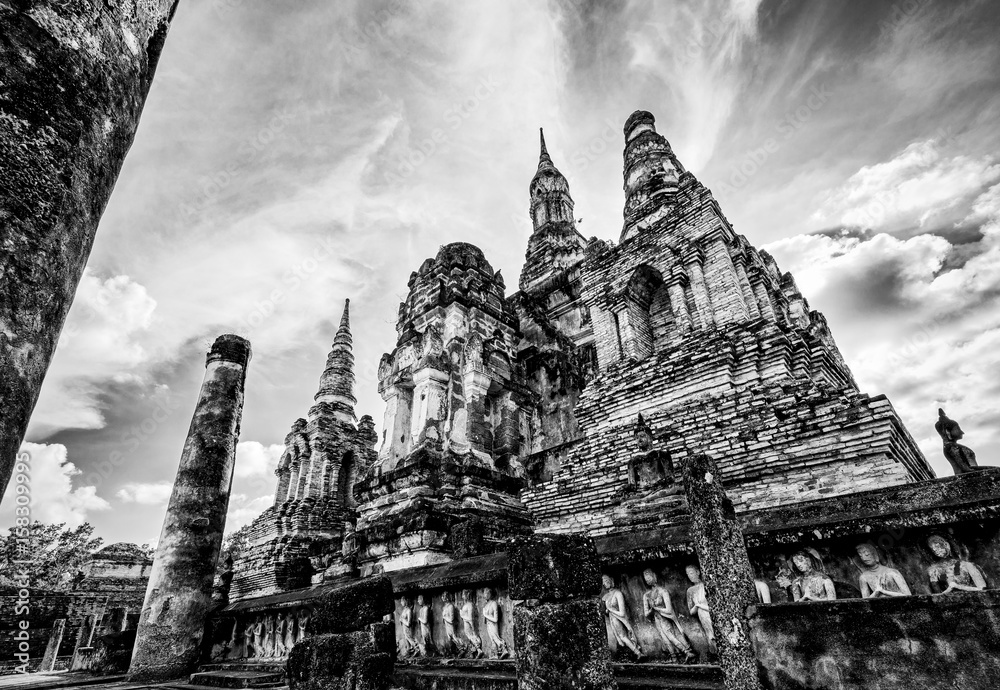 Fototapeta premium Black and white two tone vintage style, Ancient chapel among the ruins under the bright sky at Wat Maha That temple in Sukhothai Historical Park landmark of Sukhothai Province, Thailand