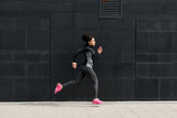 Side view of young female runner, outdoor training