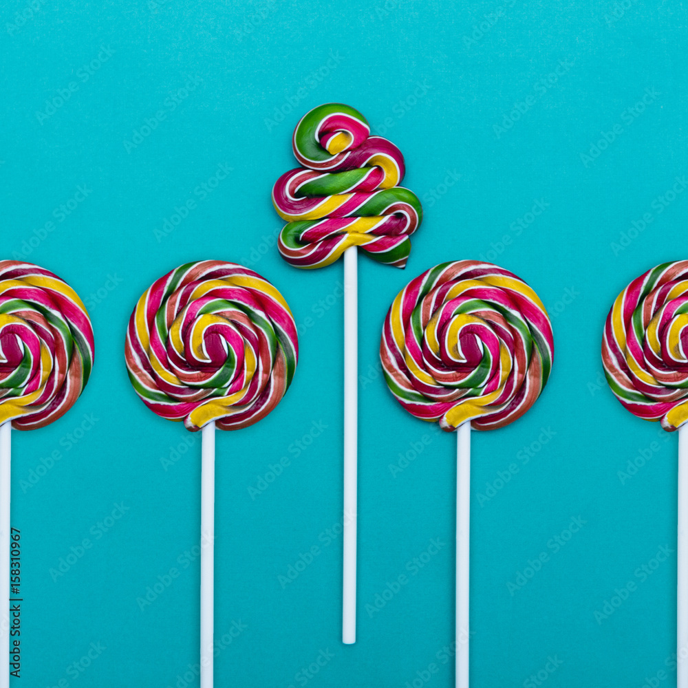 Lollipop Flat lay Minimal concept Five colorful lollipops on a blue background Round lollipops and a spiral lollipop in a row Lollipop Flat lay Minimal concept Five colorful lollipops on a blue background Round lollipops and a spiral lollipop in a row